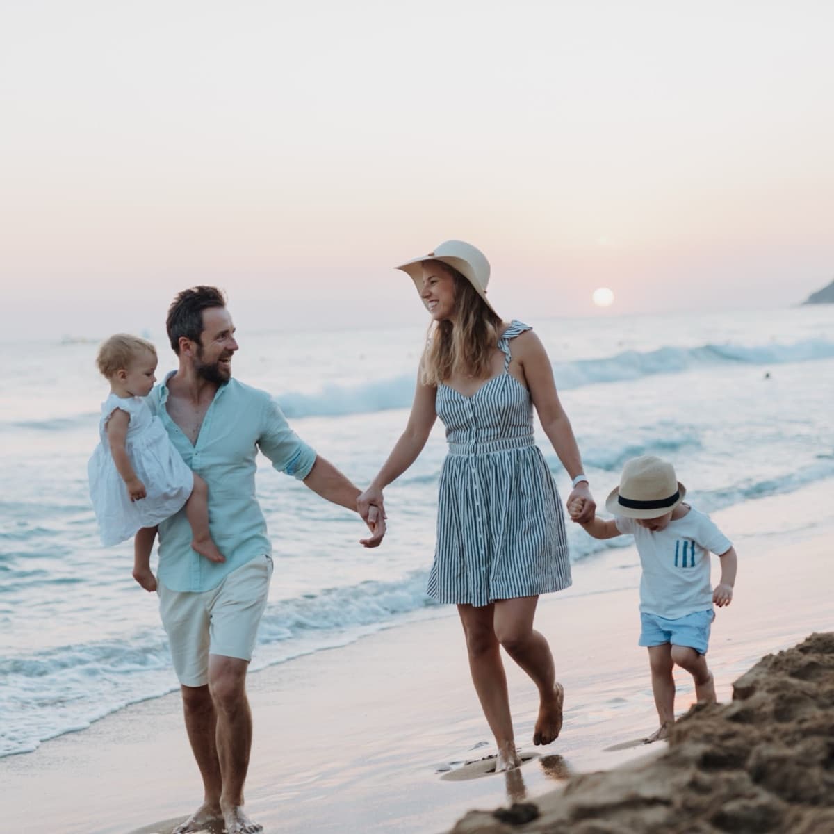 Family walking together along the shoreline